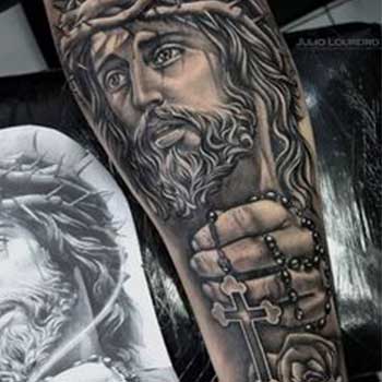 Cross tattoo with the face of Jesus