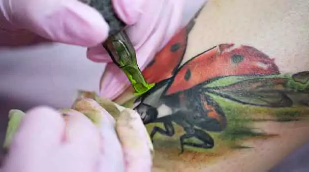 Coloring over a black tattoo