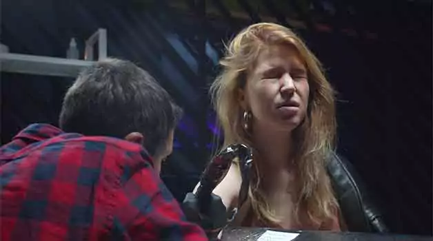 Is it painful to color over a black tattoo