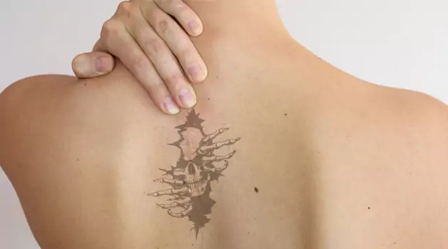 Spine tattoo to cover scar on spine area