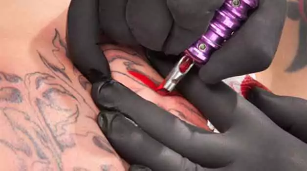 Can red ink cover black tattoo