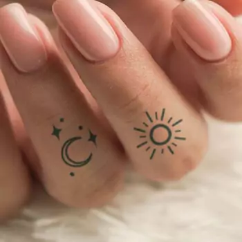 Sun and moon finger tattoo