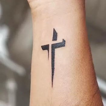 Cross Tattoo Shaped As An Arrow On The Wrist
