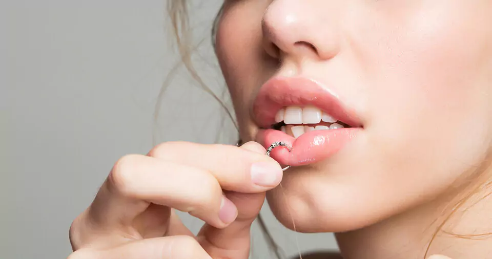 How to stop lip piercing embedding
