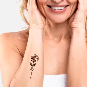 Minimalist rose tattoo with a name