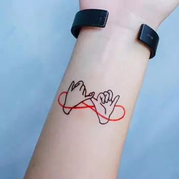 Two Pinky Fingers Tied With A Red Line